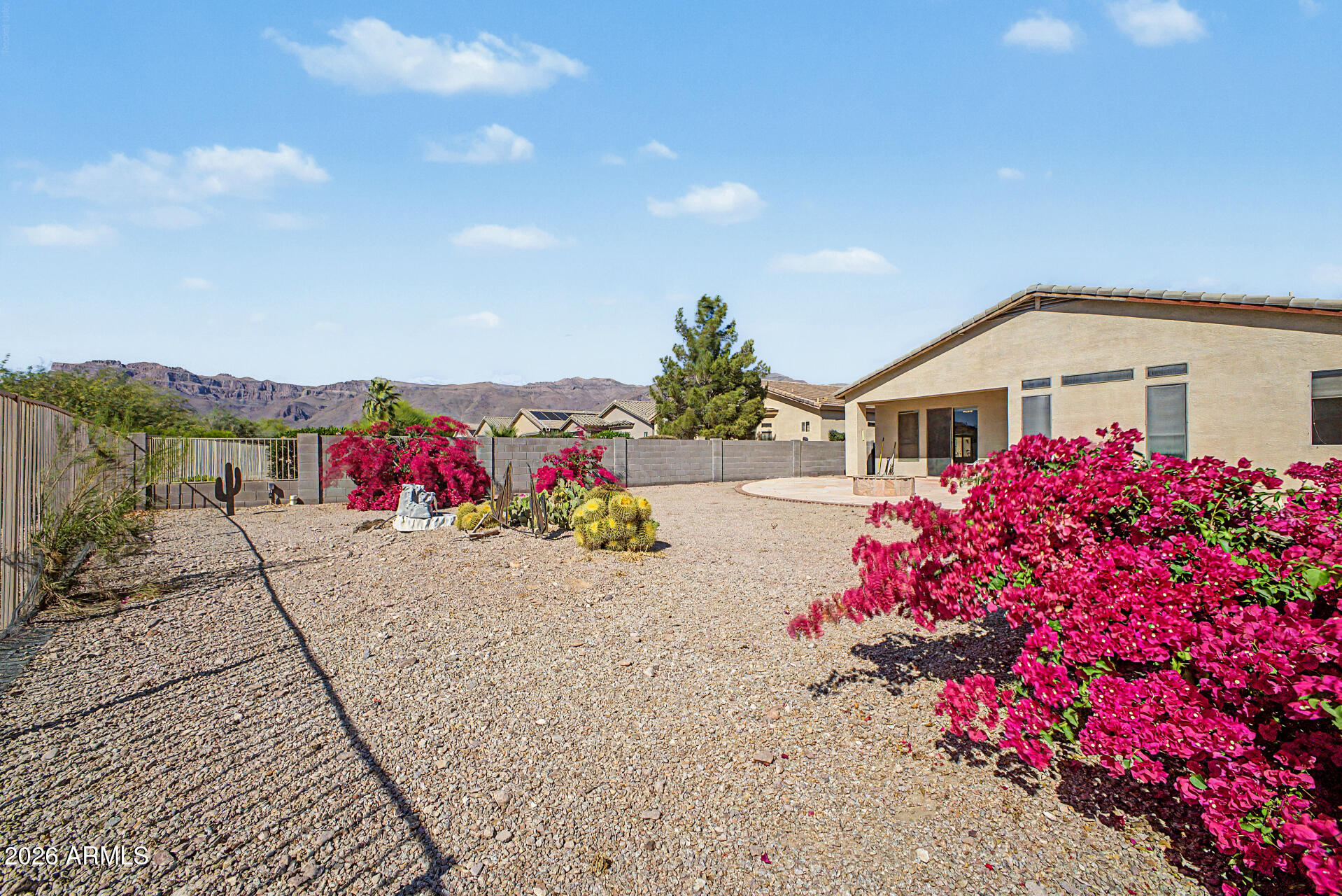 4394 South Strong Box Road Gold Canyon, AZ 85118 - Photo 32 of 33 a view of a white house with a yard and potted plants