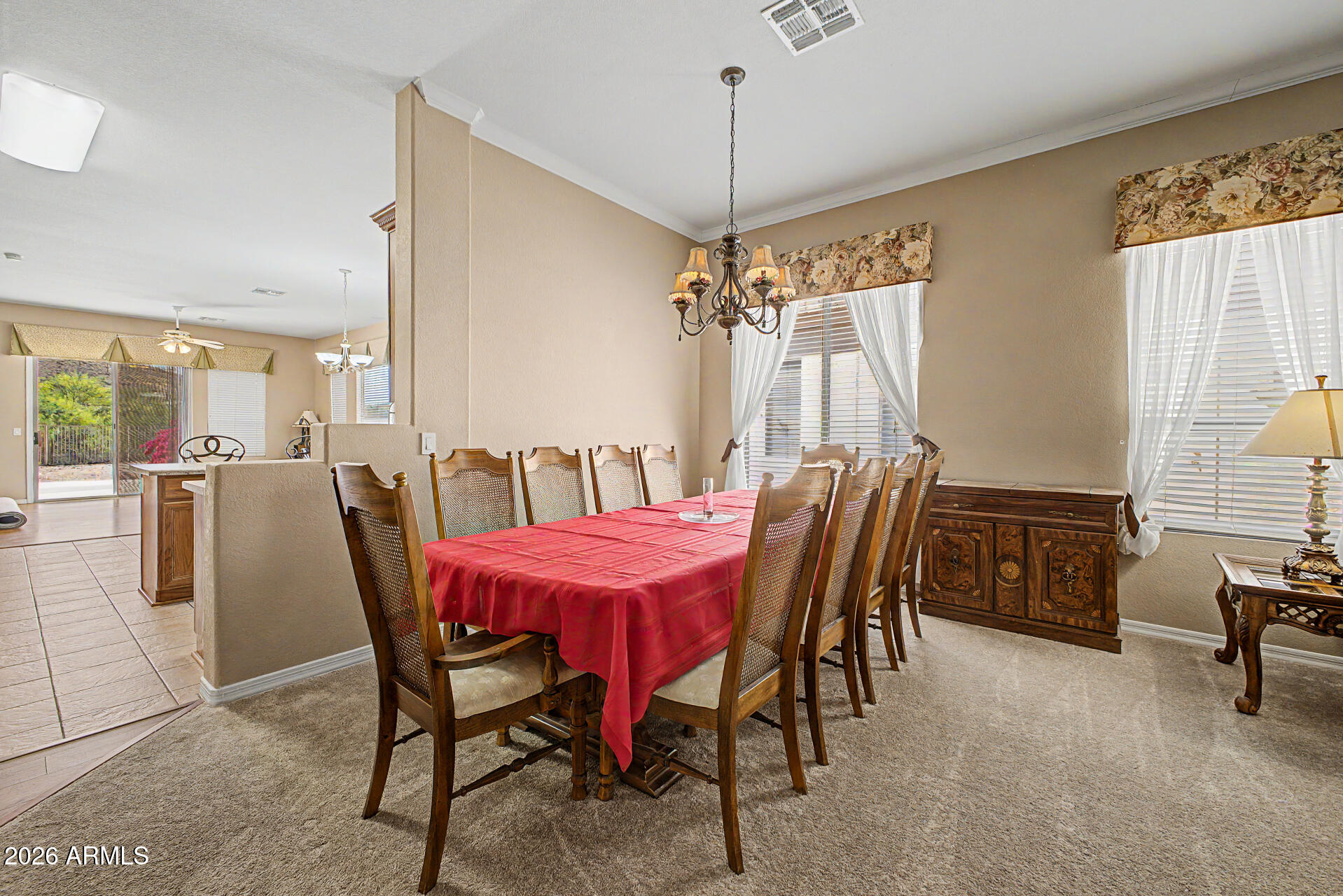 4394 South Strong Box Road Gold Canyon, AZ 85118 - Photo 8 of 33 a dining room with furniture a chandelier and window