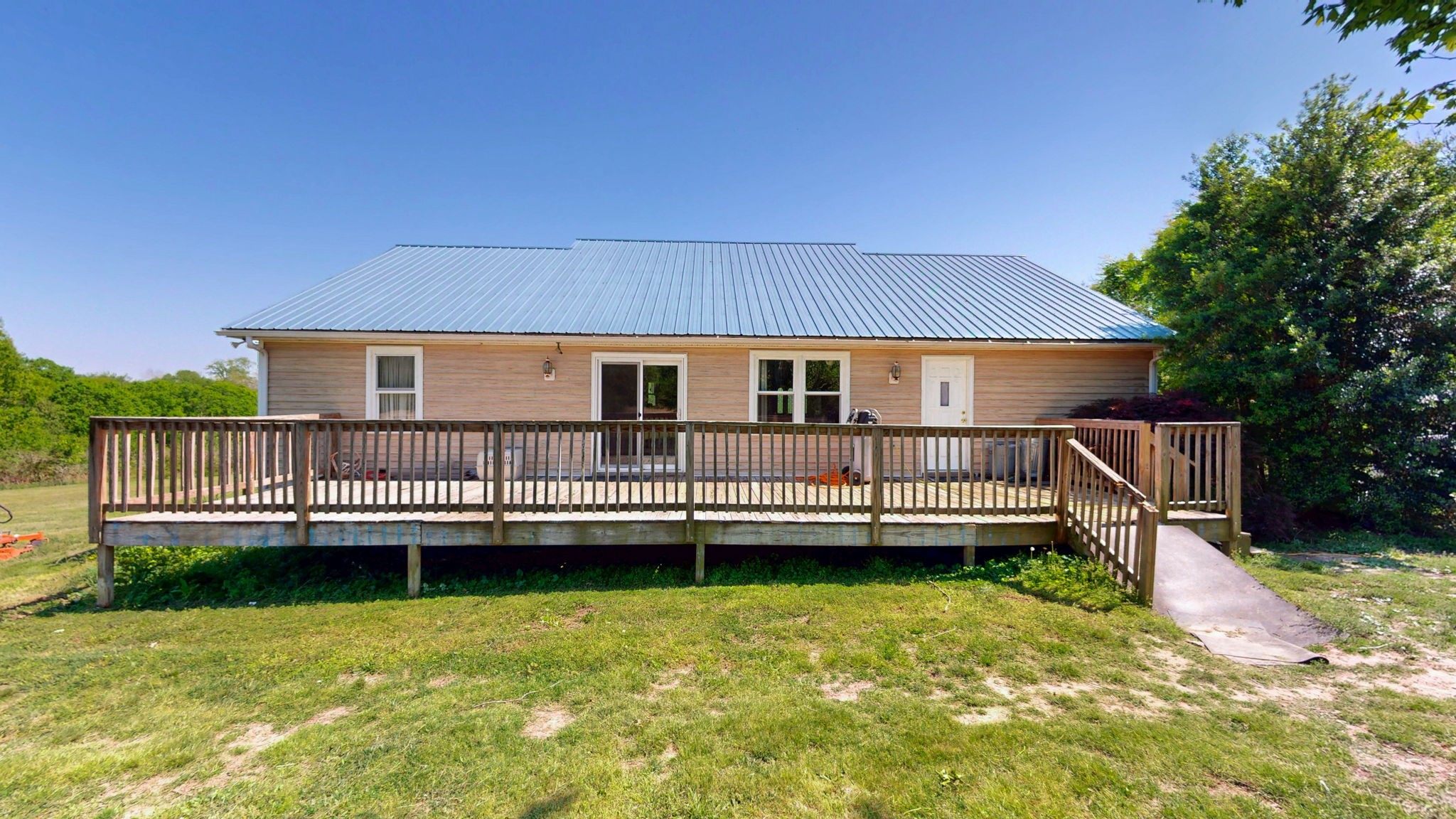 881 Coaling Road Charlotte, TN 37036 - Photo 21 of 29 a view of a house with a wooden deck and a garden