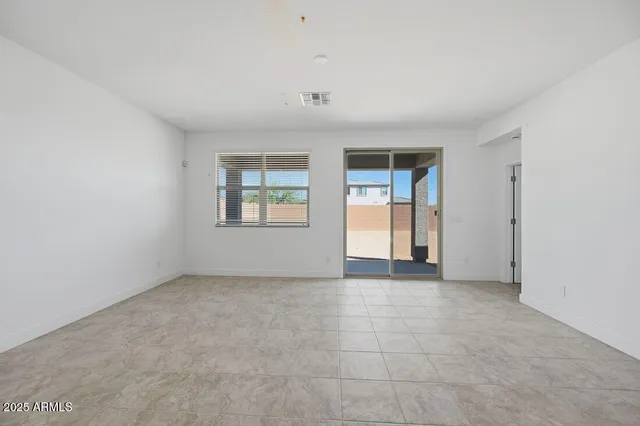 an empty room with windows and closet