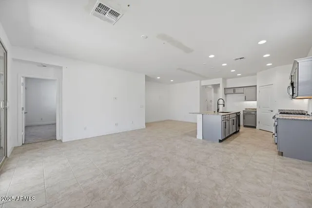 a view of a kitchen with a sink and white cabinets