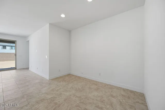 a large white kitchen with kitchen island a sink a stove a refrigerator and white cabinets