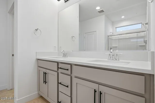 a spacious bathroom with a granite countertop sink a mirror and a