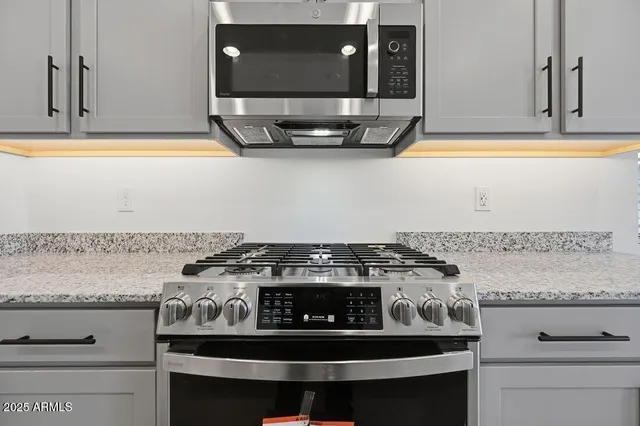 a stove top oven sitting inside of a kitchen