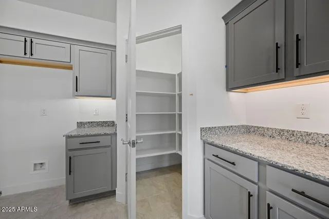 a kitchen with granite countertop cabinets stainless steel appliances and a counter space