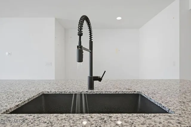 a view of a kitchen with sink and mirror
