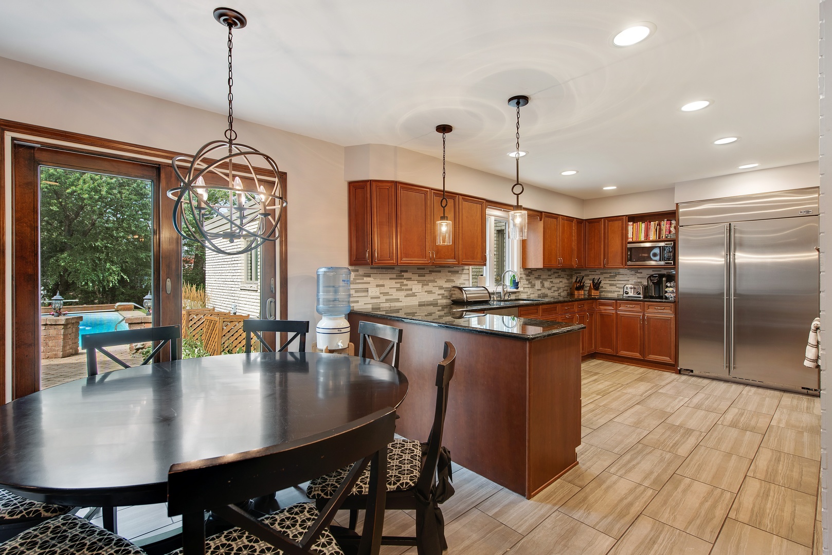 235 Maple Hill Road Glencoe, IL 60022 - Photo 35 of 35 a kitchen with stainless steel appliances granite countertop a stove a refrigerator a kitchen island a dining table and chairs