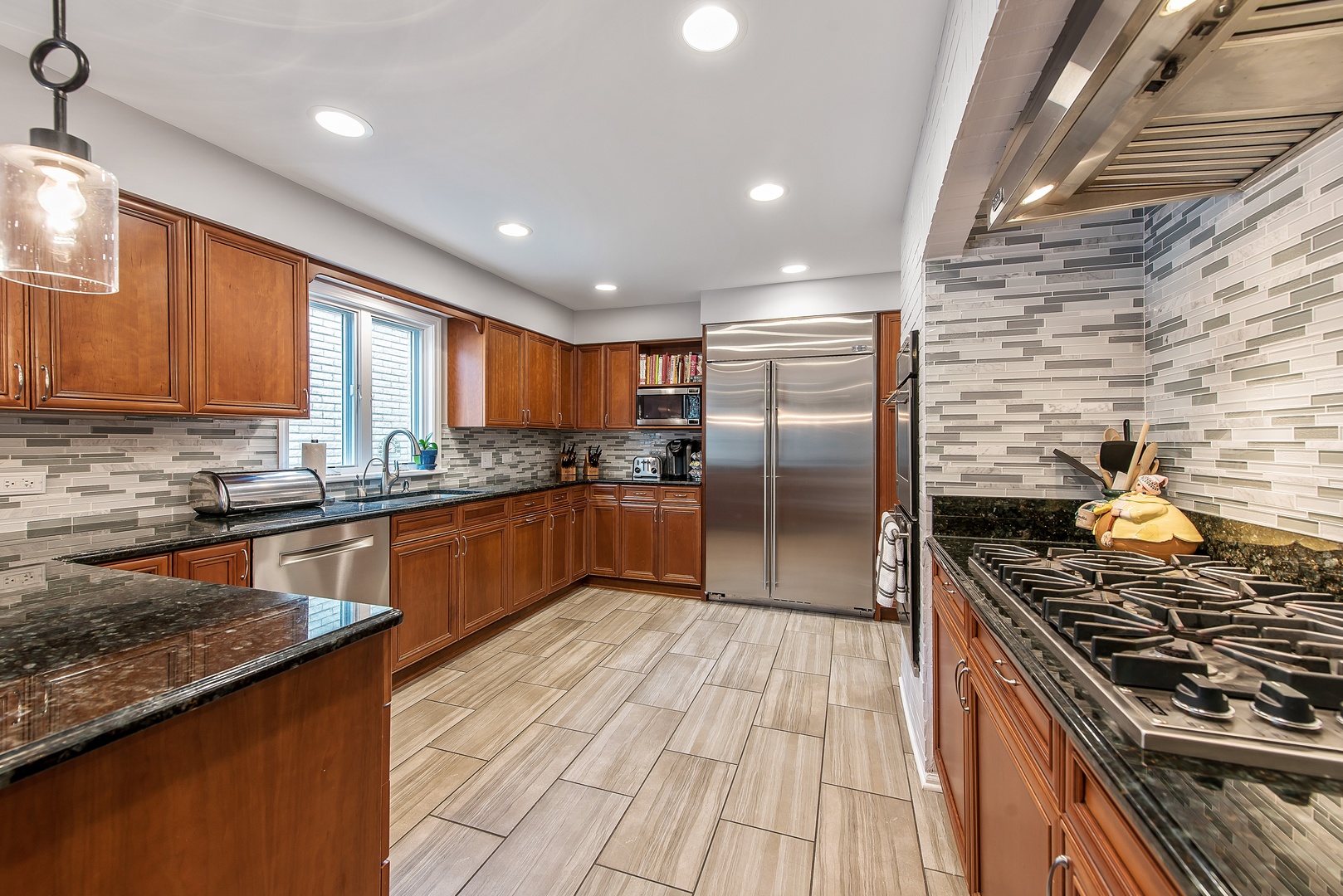 235 Maple Hill Road Glencoe, IL 60022 - Photo 7 of 35 a kitchen with stainless steel appliances granite countertop a stove a sink dishwasher a refrigerator and cabinets with wooden floor