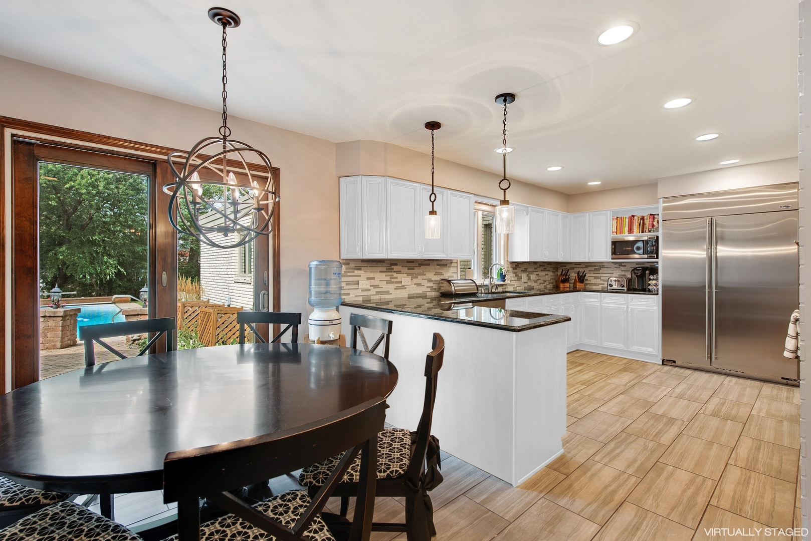 235 Maple Hill Road Glencoe, IL 60022 - Photo 10 of 35 a kitchen with counter space dining table and stainless steel appliances