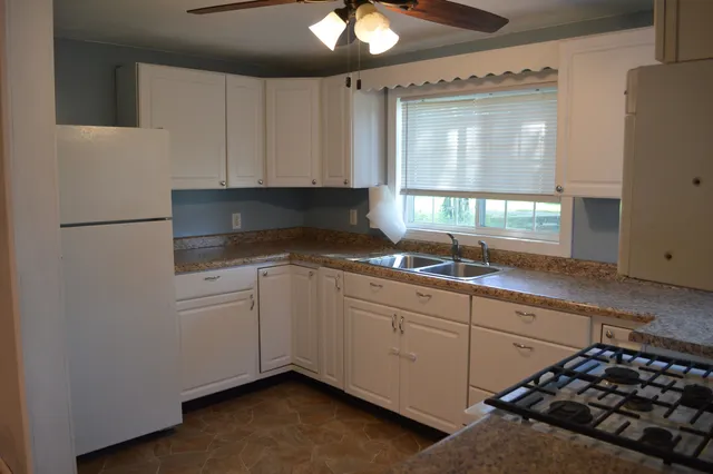a kitchen that has a sink and a stove