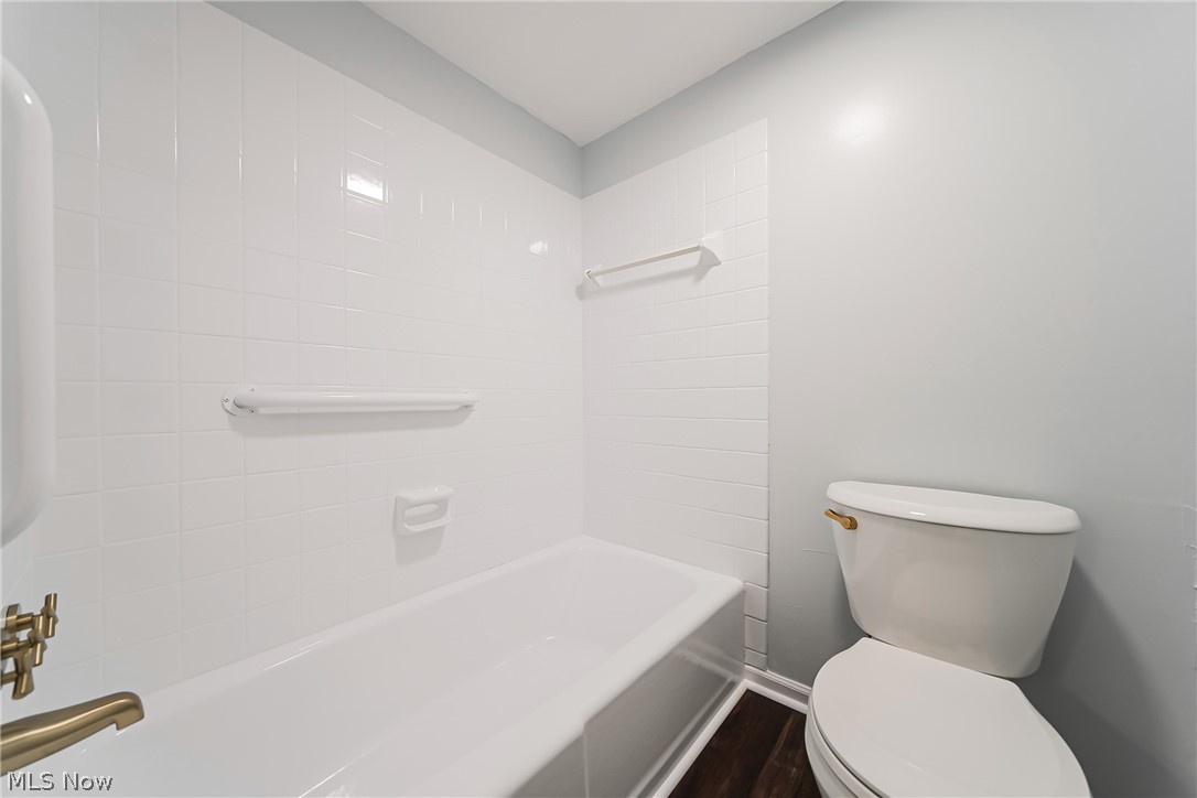 22701 Center Ridge Road, Unit 304 Rocky River, OH 44116 - Photo 20 of 31 Bathroom featuring wood-type flooring, toilet, and tiled shower / bath