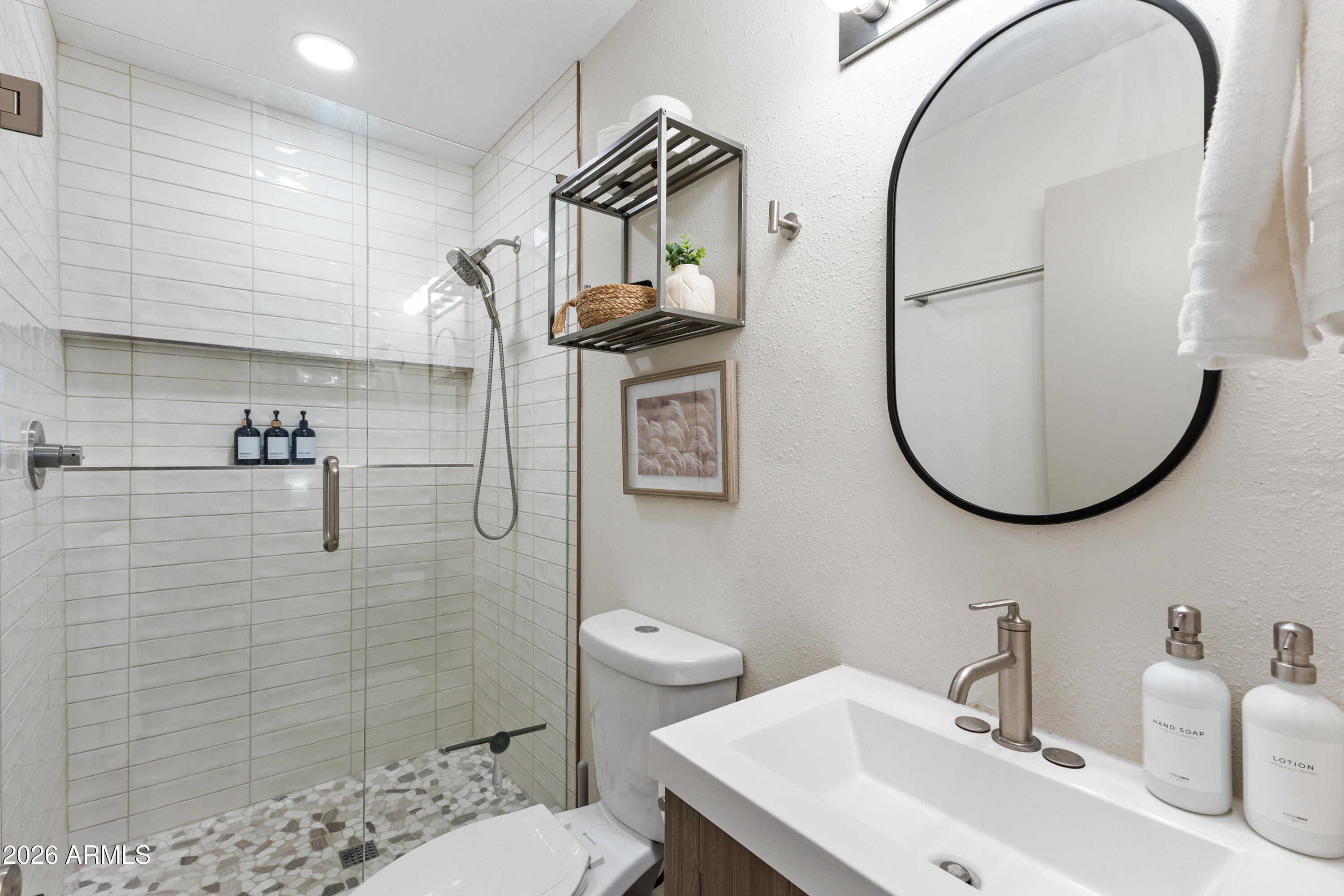 111 South Cholla Street Gilbert, AZ 85233 - Photo 24 of 34 a bathroom with a sink a toilet and a mirror