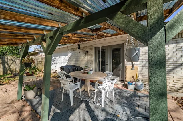 a view of a patio with table and chairs and potted plants
