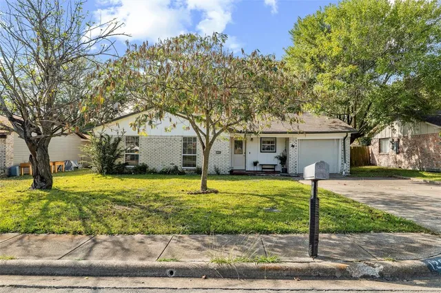a house that has a tree in front of it