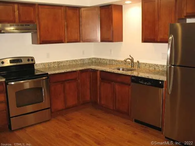 a kitchen with a sink stove and cabinets
