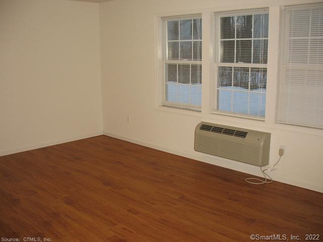 41 Grand Street, Unit 101 Danbury, CT 06810 - Photo 12 of 14 a view of a room with wooden floor and windows