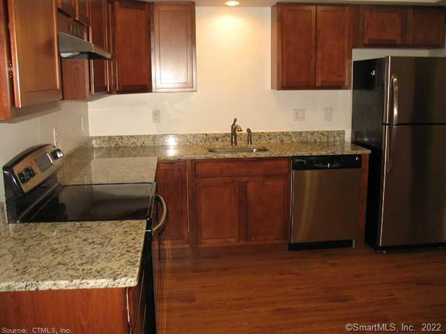 41 Grand Street, Unit 101 Danbury, CT 06810 - Photo 2 of 14 a kitchen with stainless steel appliances granite countertop a sink stove and refrigerator