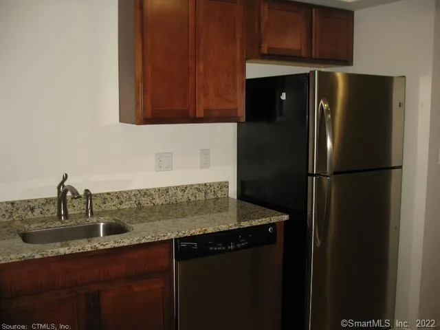 a kitchen with a sink and refrigerator