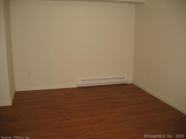 41 Grand Street, Unit 101 Danbury, CT 06810 - Photo 4 of 14 a view of an empty room with wooden floor