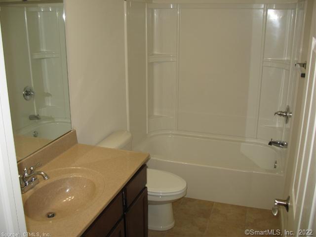 41 Grand Street, Unit 101 Danbury, CT 06810 - Photo 8 of 14 a bathroom with a sink a toilet and shower