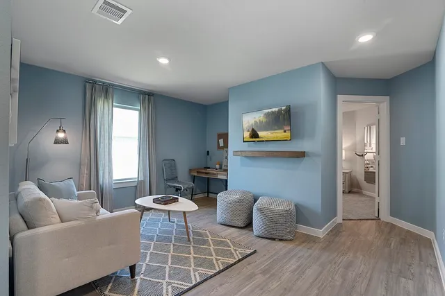 a living room with furniture a window and a dining table