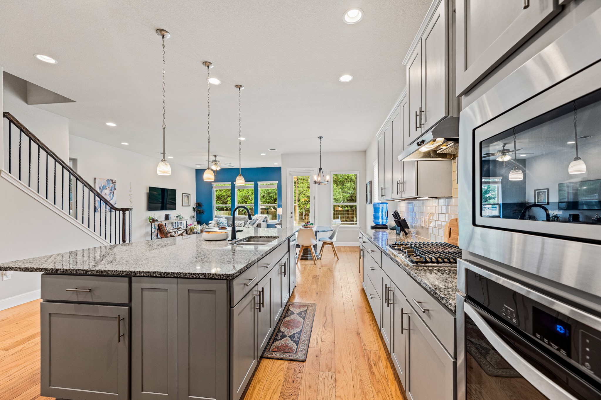 108 Redtail Lane Leander, TX 78641 - Photo 11 of 39 An open-concept kitchen with hardwood floors and granite countertops, perfect for entertaining.