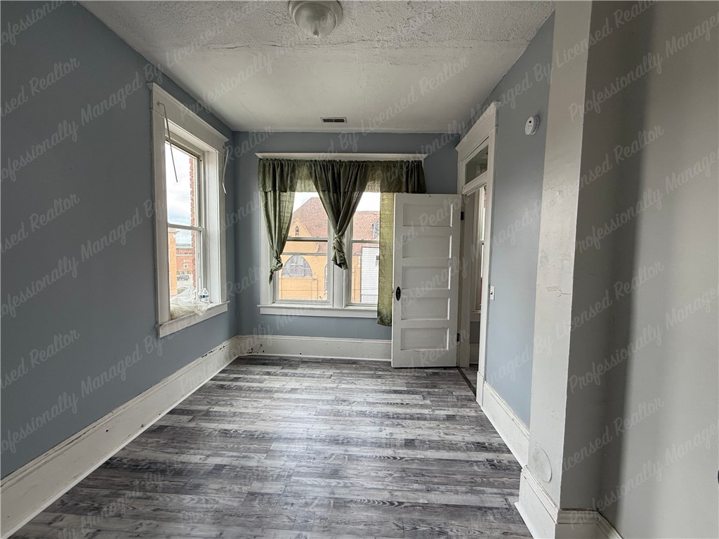 44 West High Street, Unit D Springfield, OH 45502 - Photo 12 of 25 This bright room features durable flooring, ample natural light, and offers flexible living possibilities.