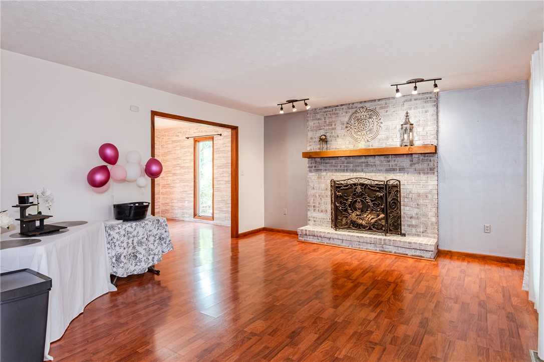 6750 Little Twin Road Germantown, OH 45327 - Photo 5 of 88 This inviting living area features warm wood flooring and a classic brick fireplace.