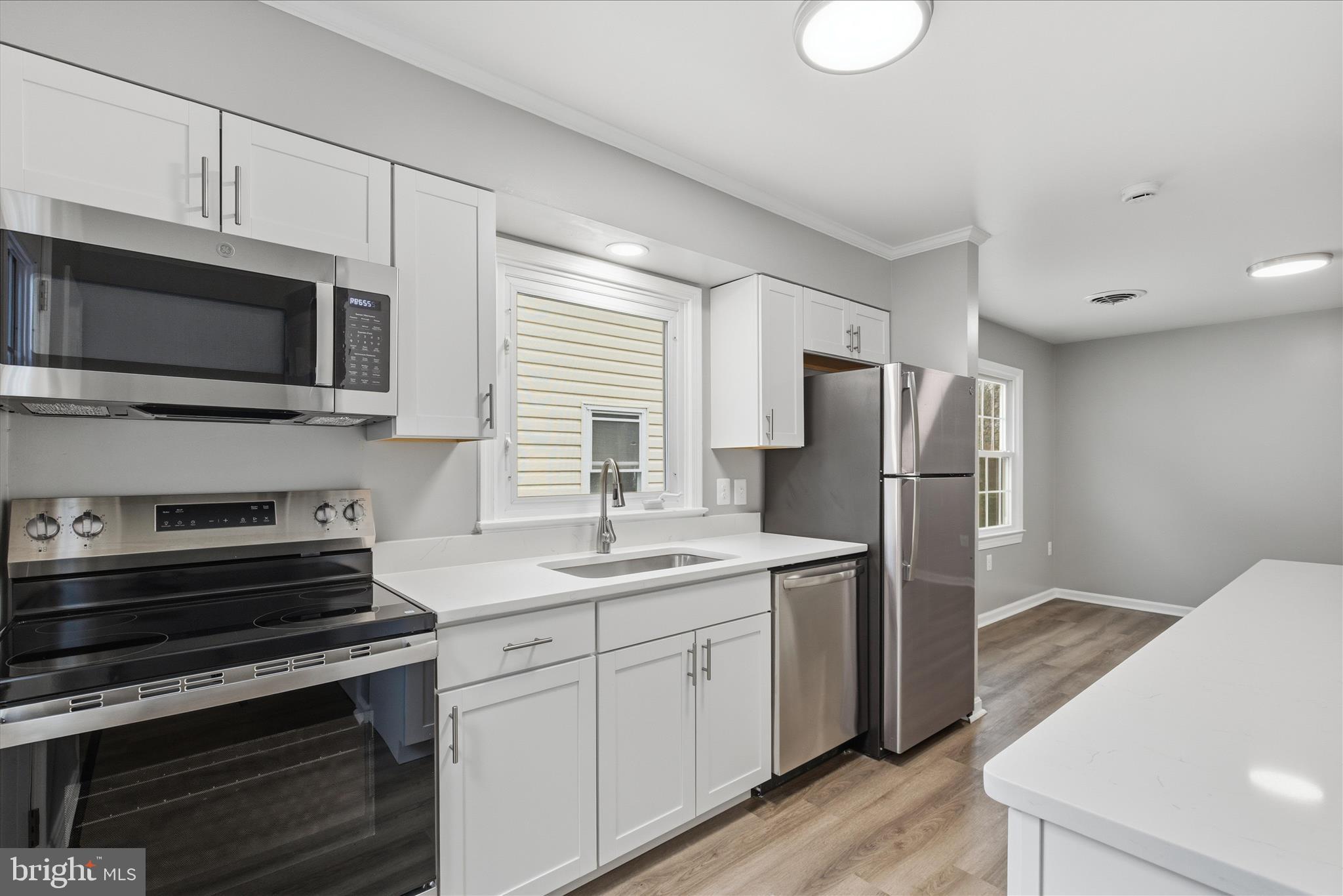 130 Cox Road Huntingtown, MD 20639 - Photo 11 of 41 a kitchen with stainless steel appliances a stove microwave and refrigerator