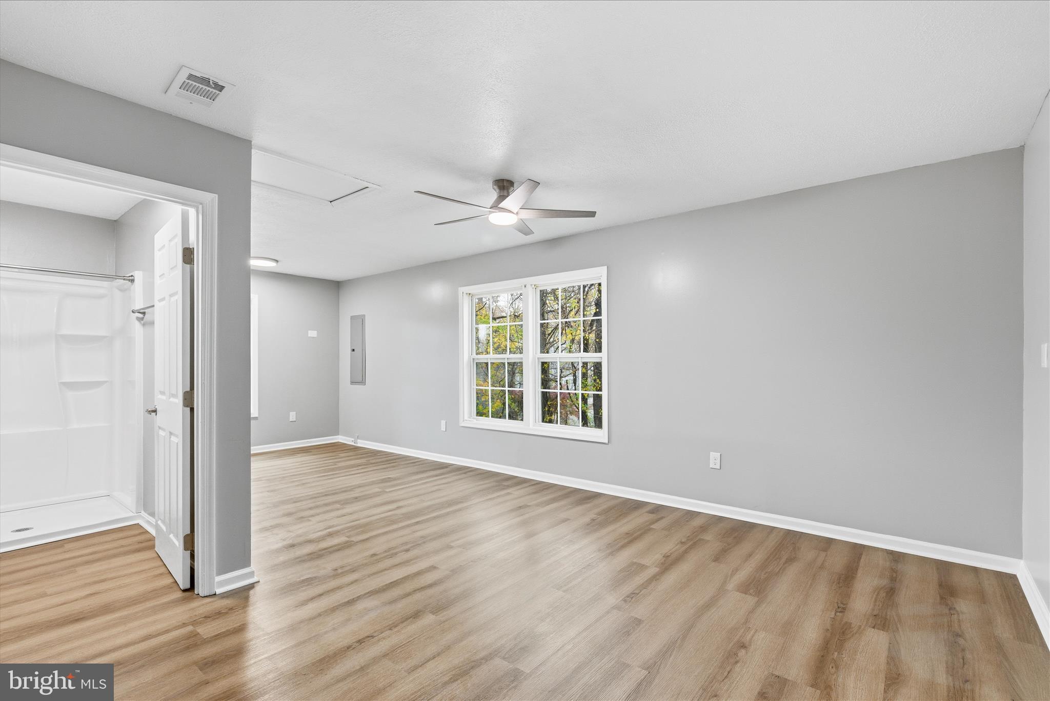 130 Cox Road Huntingtown, MD 20639 - Photo 17 of 41 a view of an empty room with wooden floor and a window