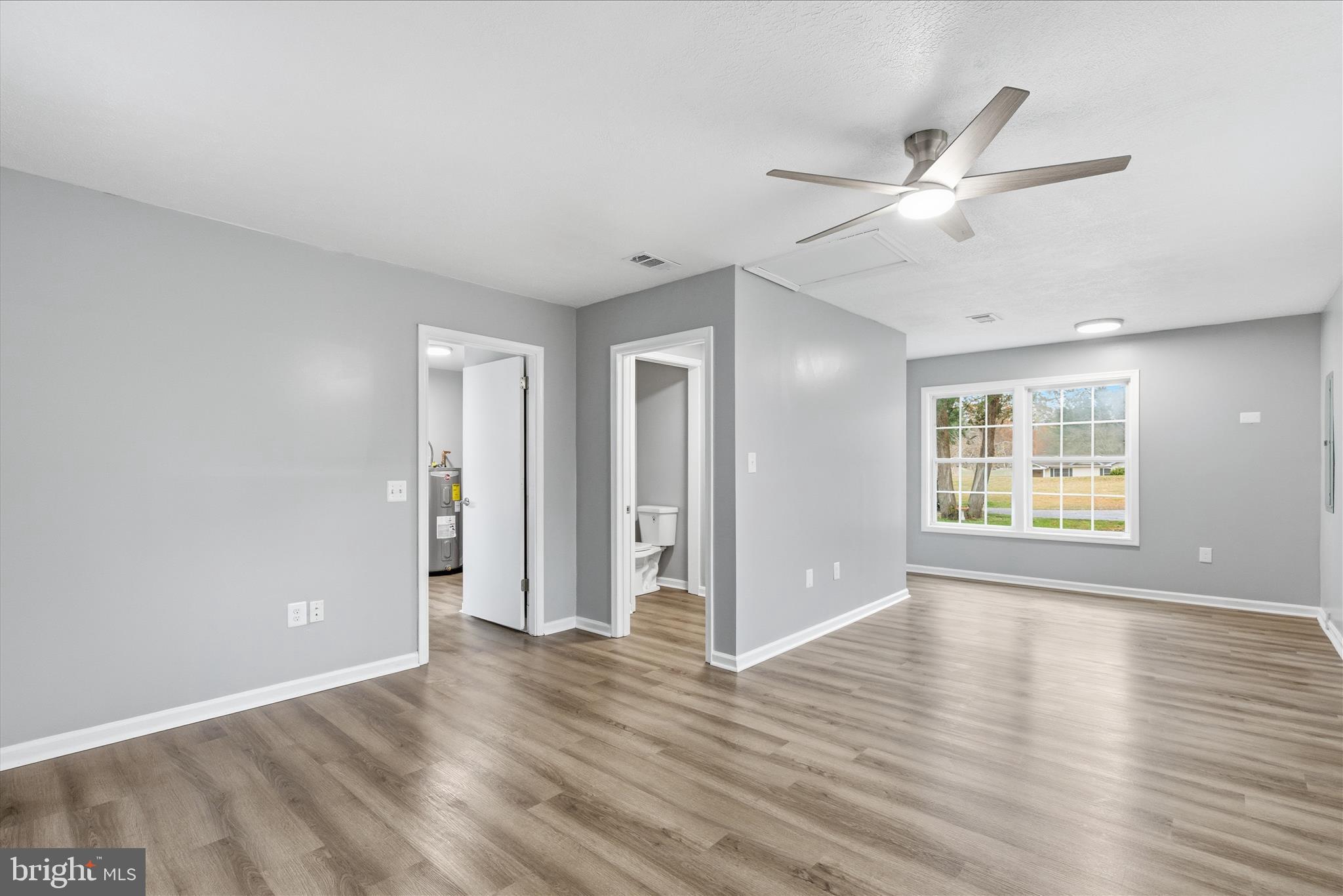 130 Cox Road Huntingtown, MD 20639 - Photo 18 of 41 a view of an empty room with wooden floor and a window