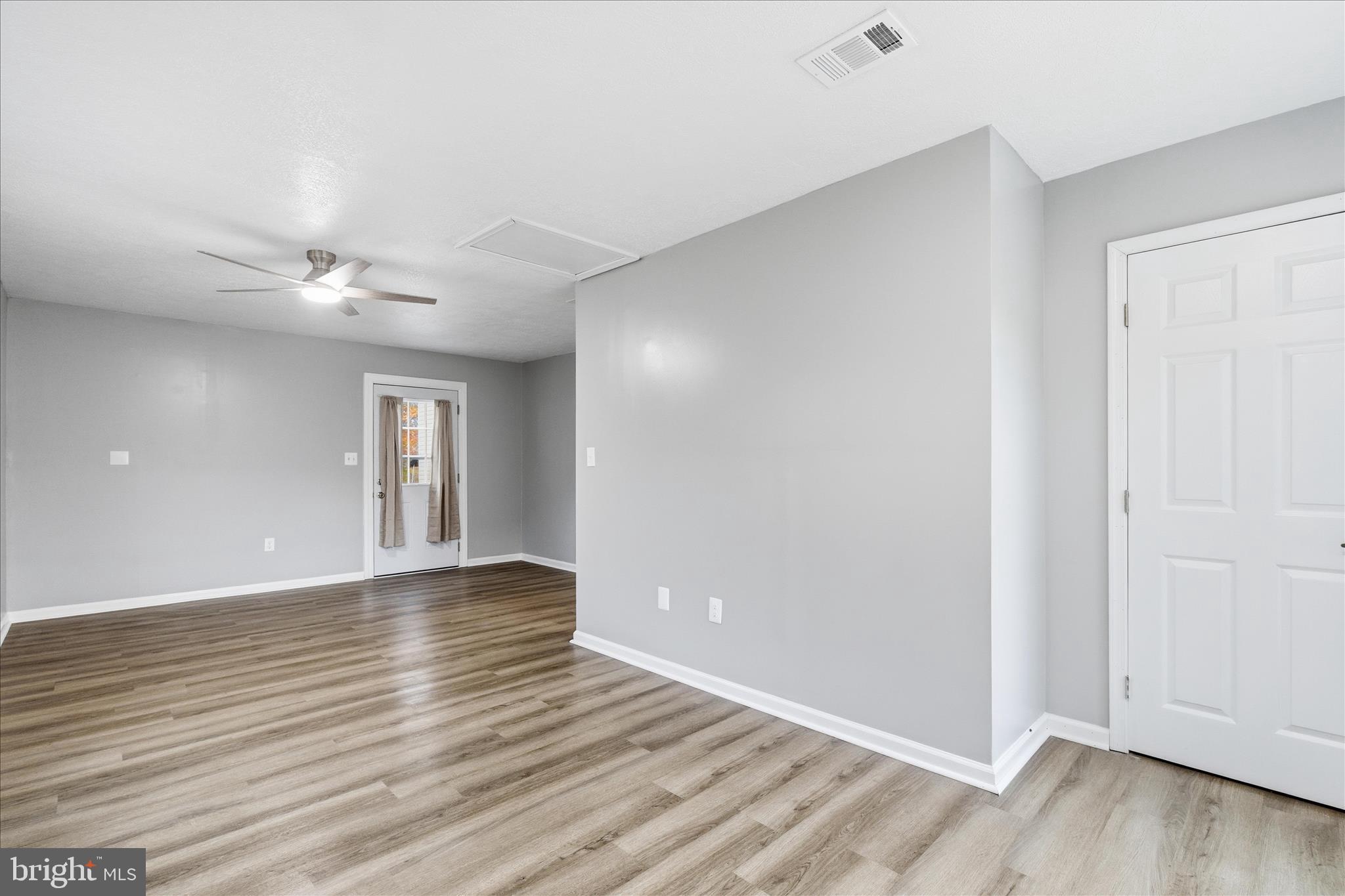 130 Cox Road Huntingtown, MD 20639 - Photo 19 of 41 a view of an empty room with wooden floor and a ceiling fan