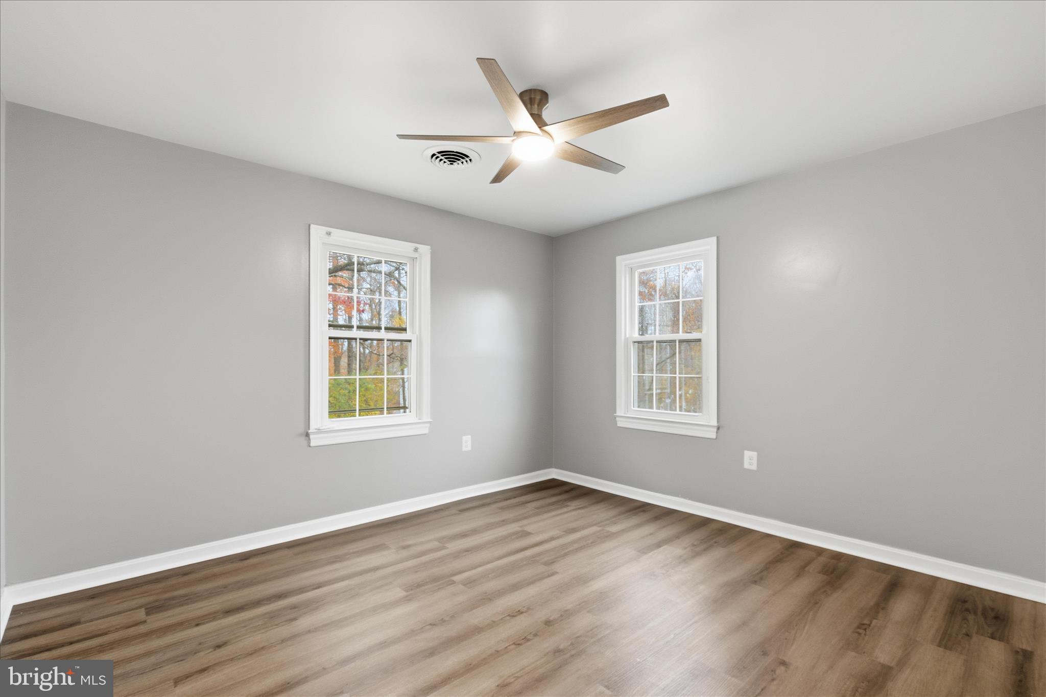 130 Cox Road Huntingtown, MD 20639 - Photo 22 of 41 a view of an empty room with wooden floor and a window