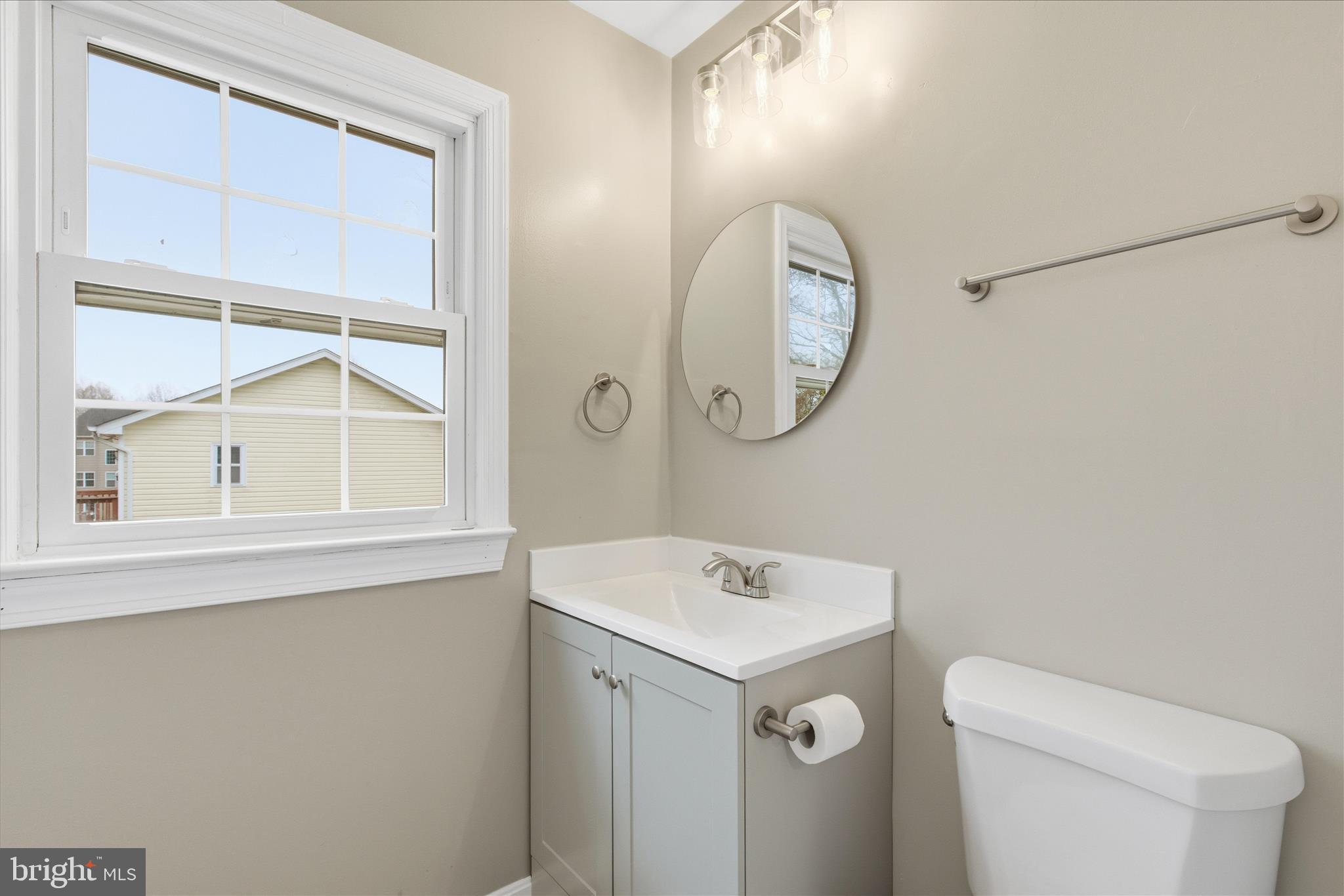 130 Cox Road Huntingtown, MD 20639 - Photo 24 of 41 a bathroom with a toilet a sink and a mirror