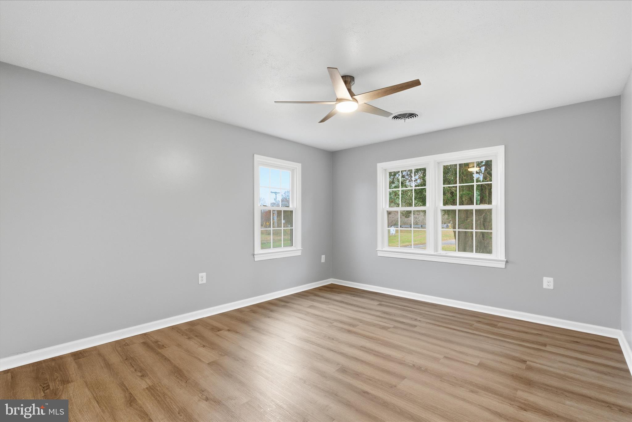 130 Cox Road Huntingtown, MD 20639 - Photo 26 of 41 a view of an empty room with wooden floor and a window