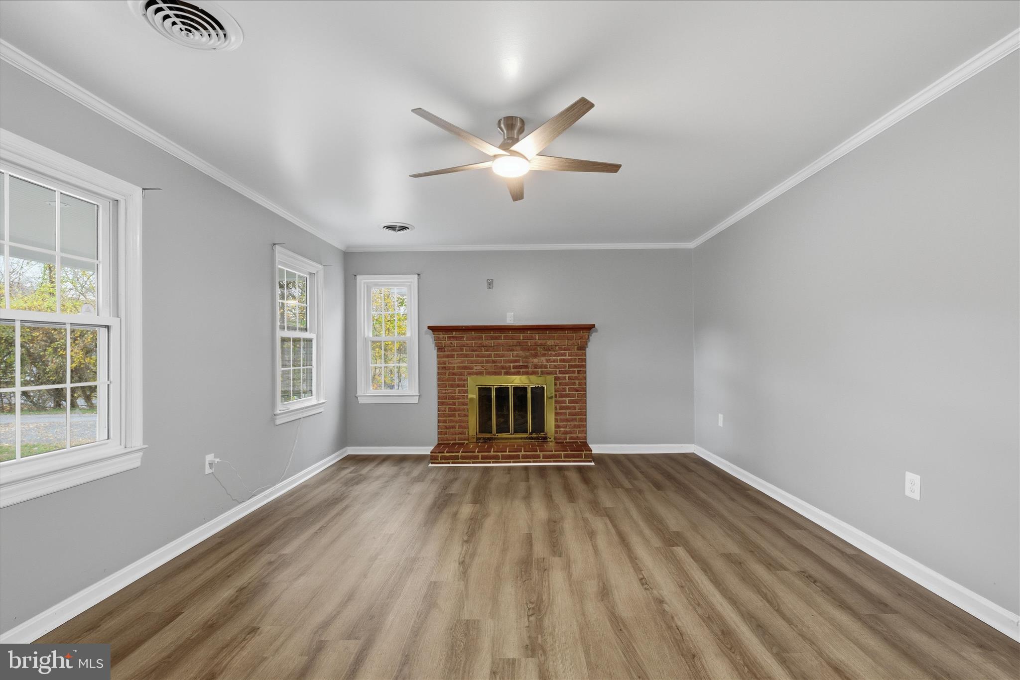 130 Cox Road Huntingtown, MD 20639 - Photo 6 of 41 a view of an empty room with a window and fireplace