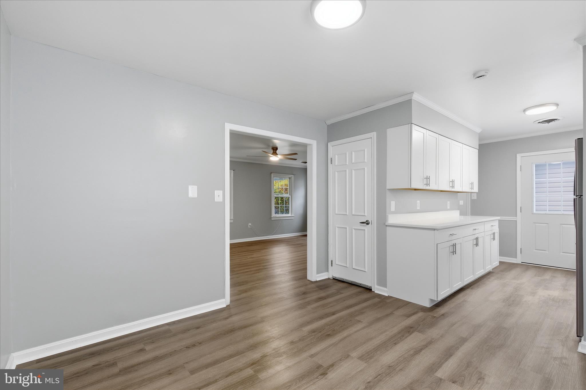 130 Cox Road Huntingtown, MD 20639 - Photo 8 of 41 a view of a kitchen with wooden floor and white doors