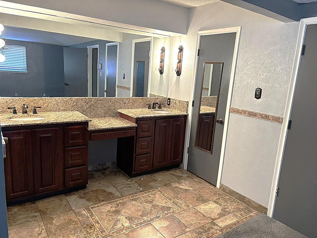 3042 Kiest Ridge Drive Dallas, TX 75233 - Photo 20 of 27 a bathroom with a granite countertop sink and a mirror