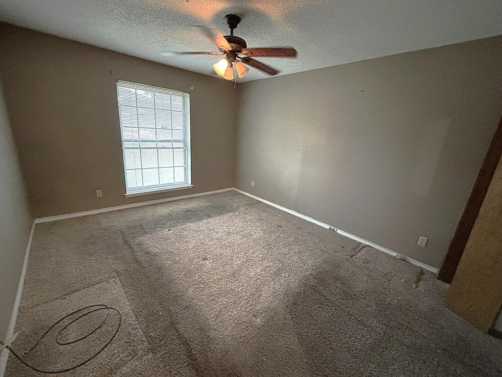 3042 Kiest Ridge Drive Dallas, TX 75233 - Photo 24 of 27 an empty room with windows and ceiling fan