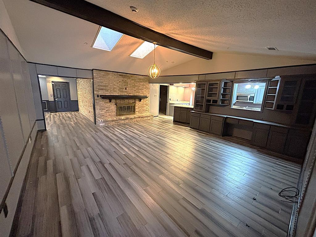 3042 Kiest Ridge Drive Dallas, TX 75233 - Photo 3 of 27 a view of empty room with wooden floor and fireplace