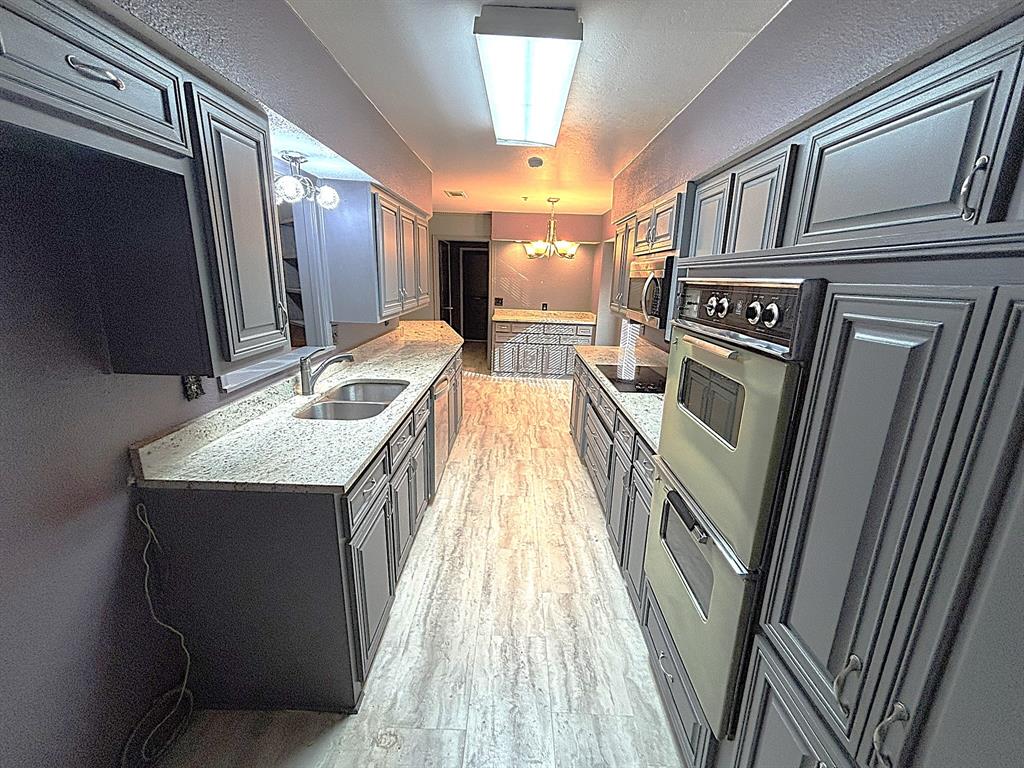 3042 Kiest Ridge Drive Dallas, TX 75233 - Photo 8 of 27 a kitchen with sink and refrigerator