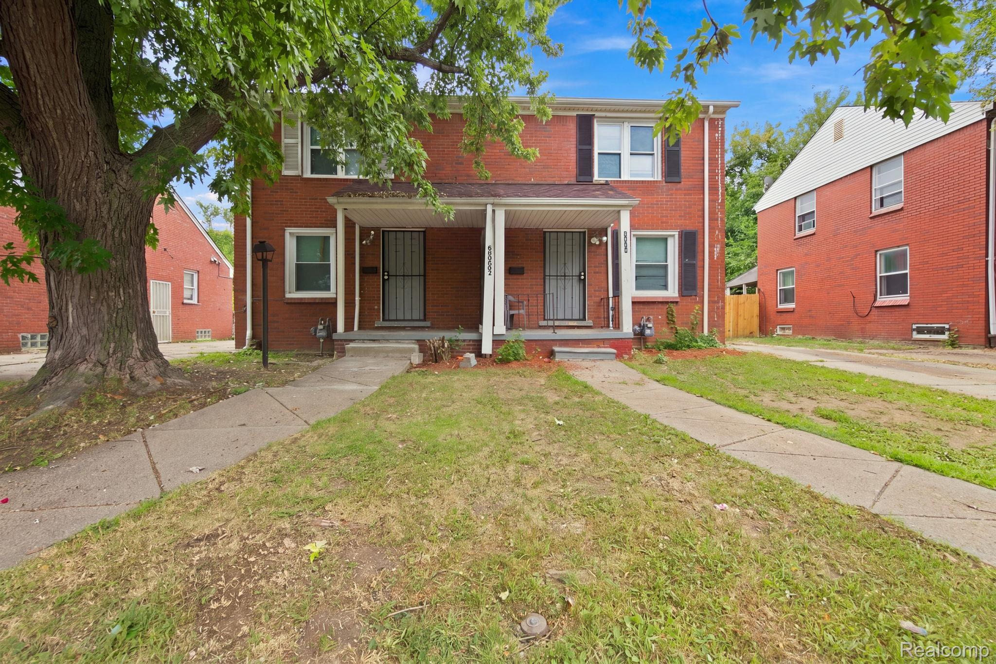 8882 Evergreen Road Detroit, MI 48228 - Photo 3 of 21 Brick exterior with white trim, covered front entries, and mature trees