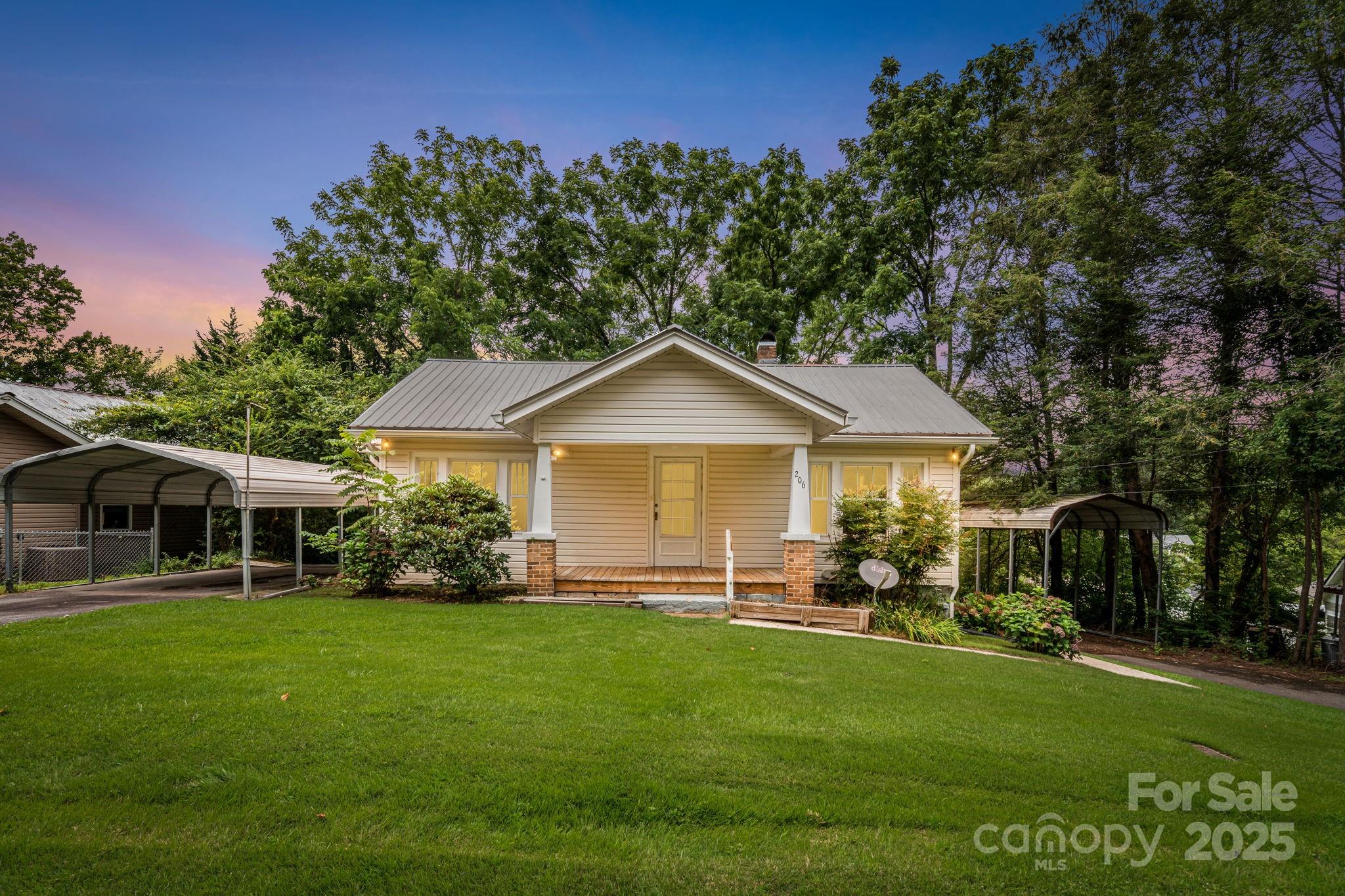 206 Rhododendron Drive Brevard, NC 28712 - Photo 1 of 36 a front view of a house with a yard and green space