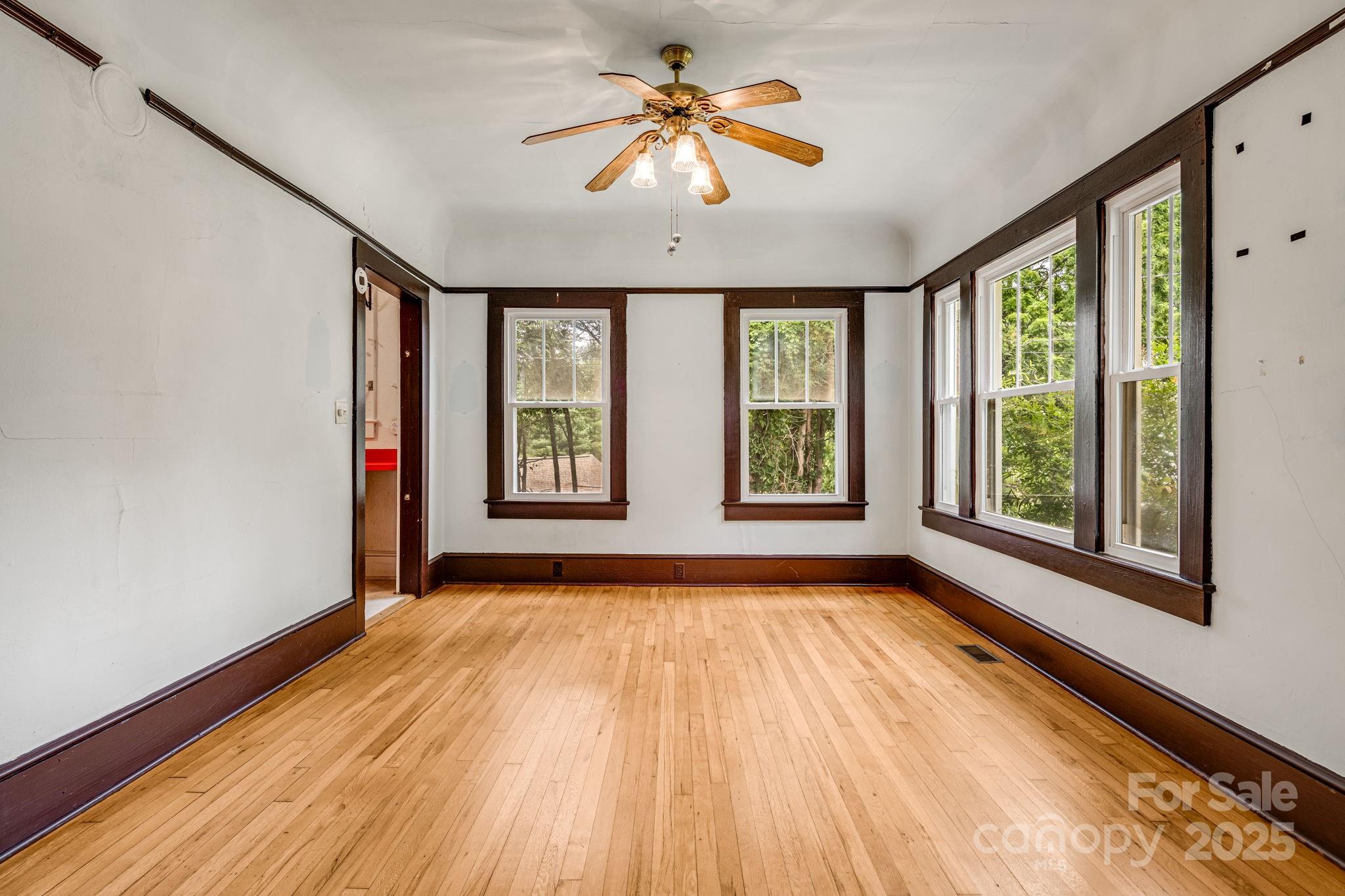 206 Rhododendron Drive Brevard, NC 28712 - Photo 12 of 36 wooden floor in an empty room with a window