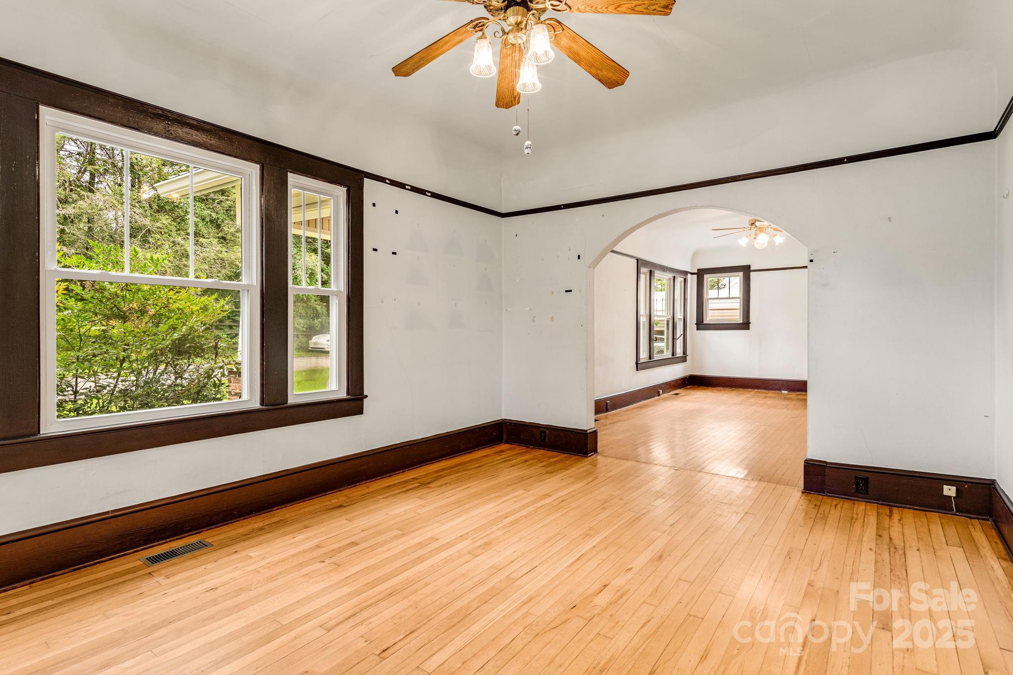 206 Rhododendron Drive Brevard, NC 28712 - Photo 13 of 36 a view of empty room with wooden floor and fan