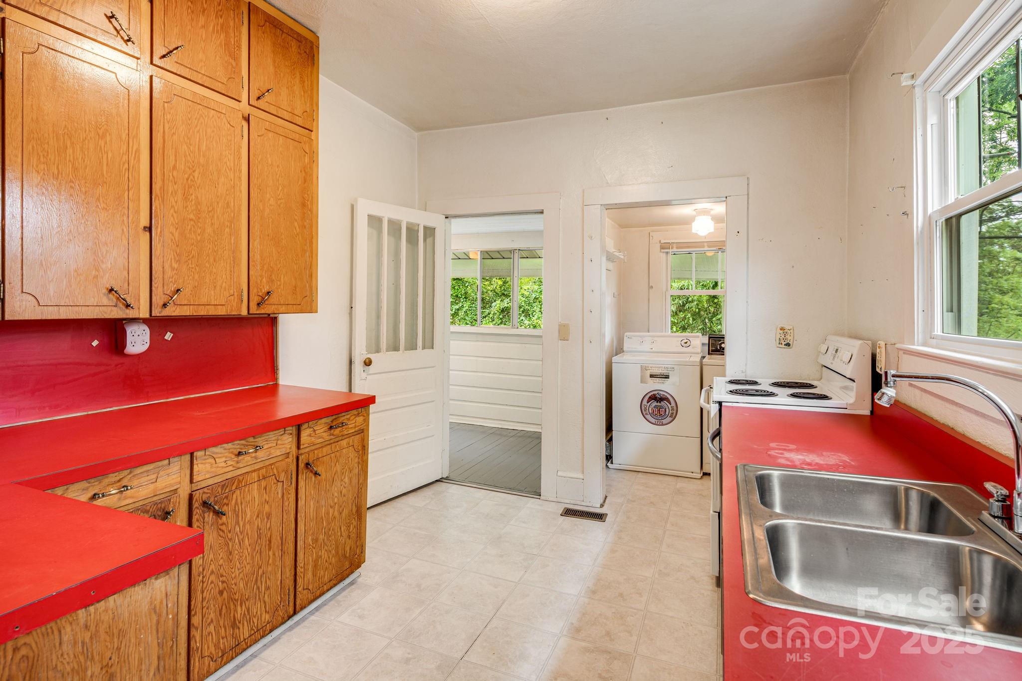 206 Rhododendron Drive Brevard, NC 28712 - Photo 15 of 36 a kitchen that has a sink and a stove