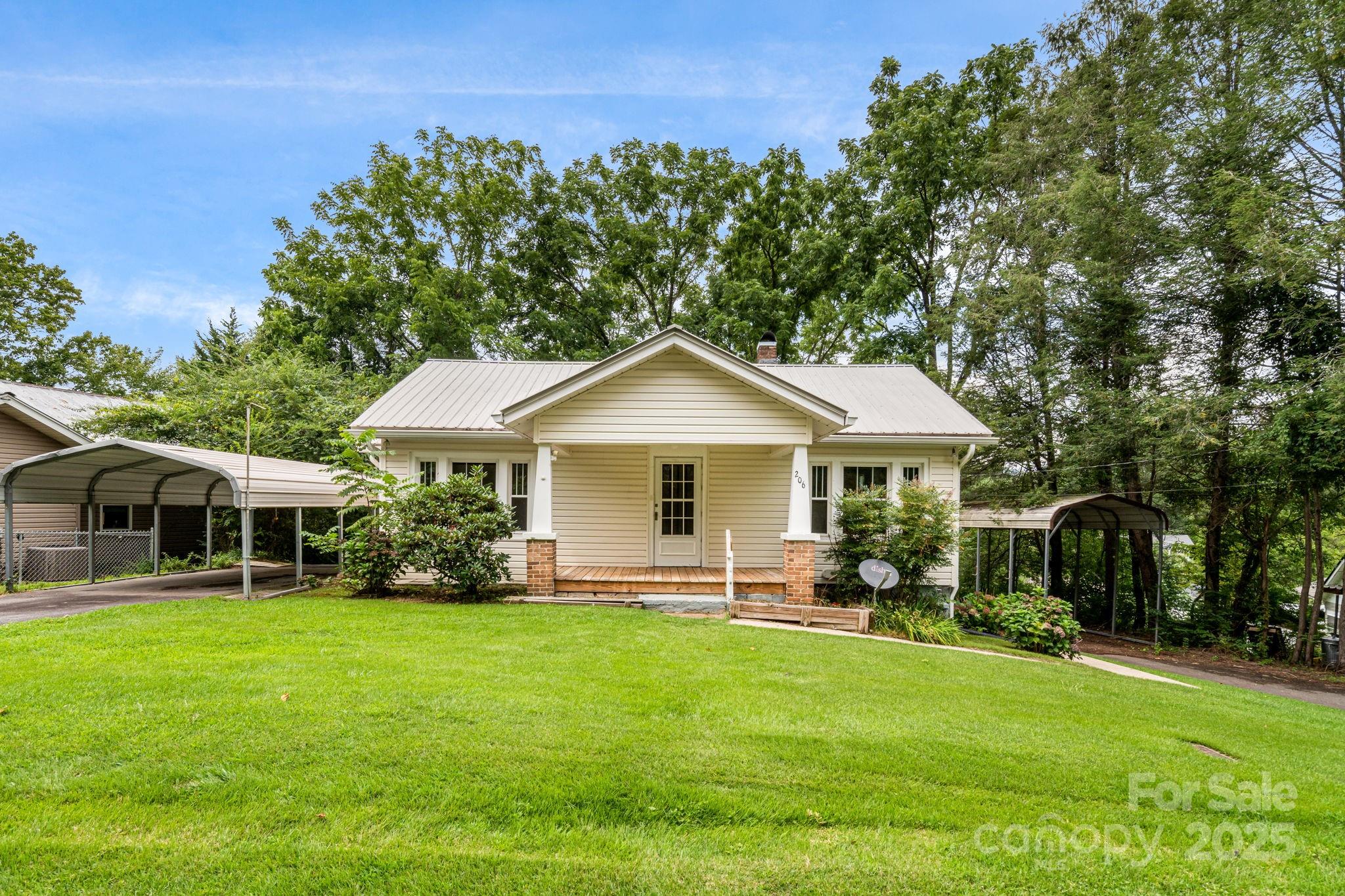 206 Rhododendron Drive Brevard, NC 28712 - Photo 2 of 36 a front view of a house with garden