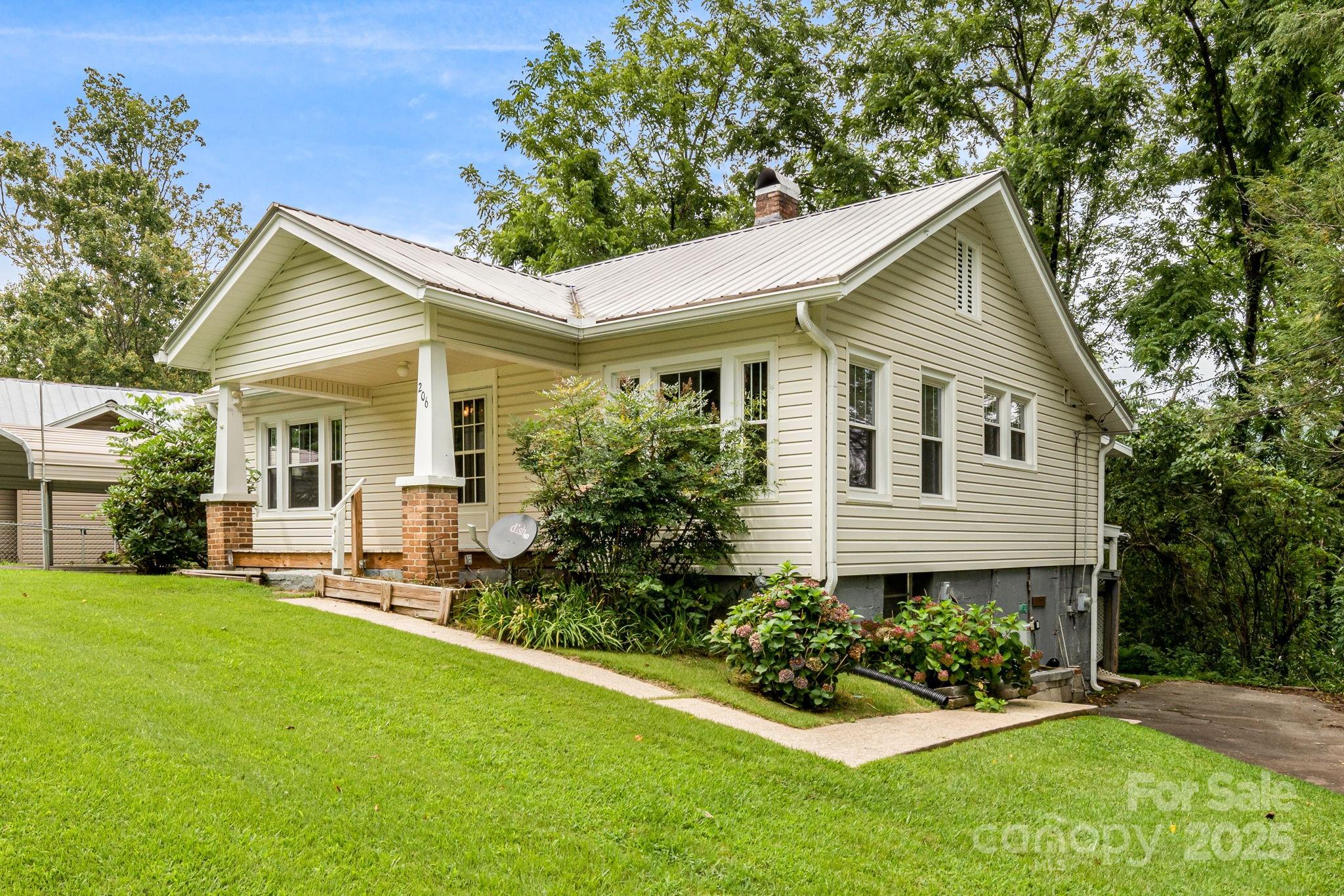 206 Rhododendron Drive Brevard, NC 28712 - Photo 3 of 36 a front view of a house with a yard