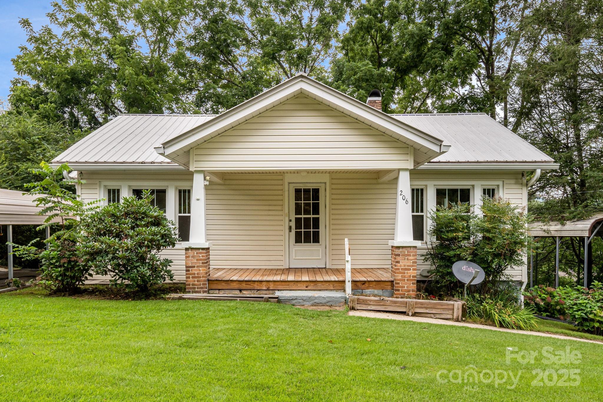 206 Rhododendron Drive Brevard, NC 28712 - Photo 4 of 36 a front view of a house with a yard
