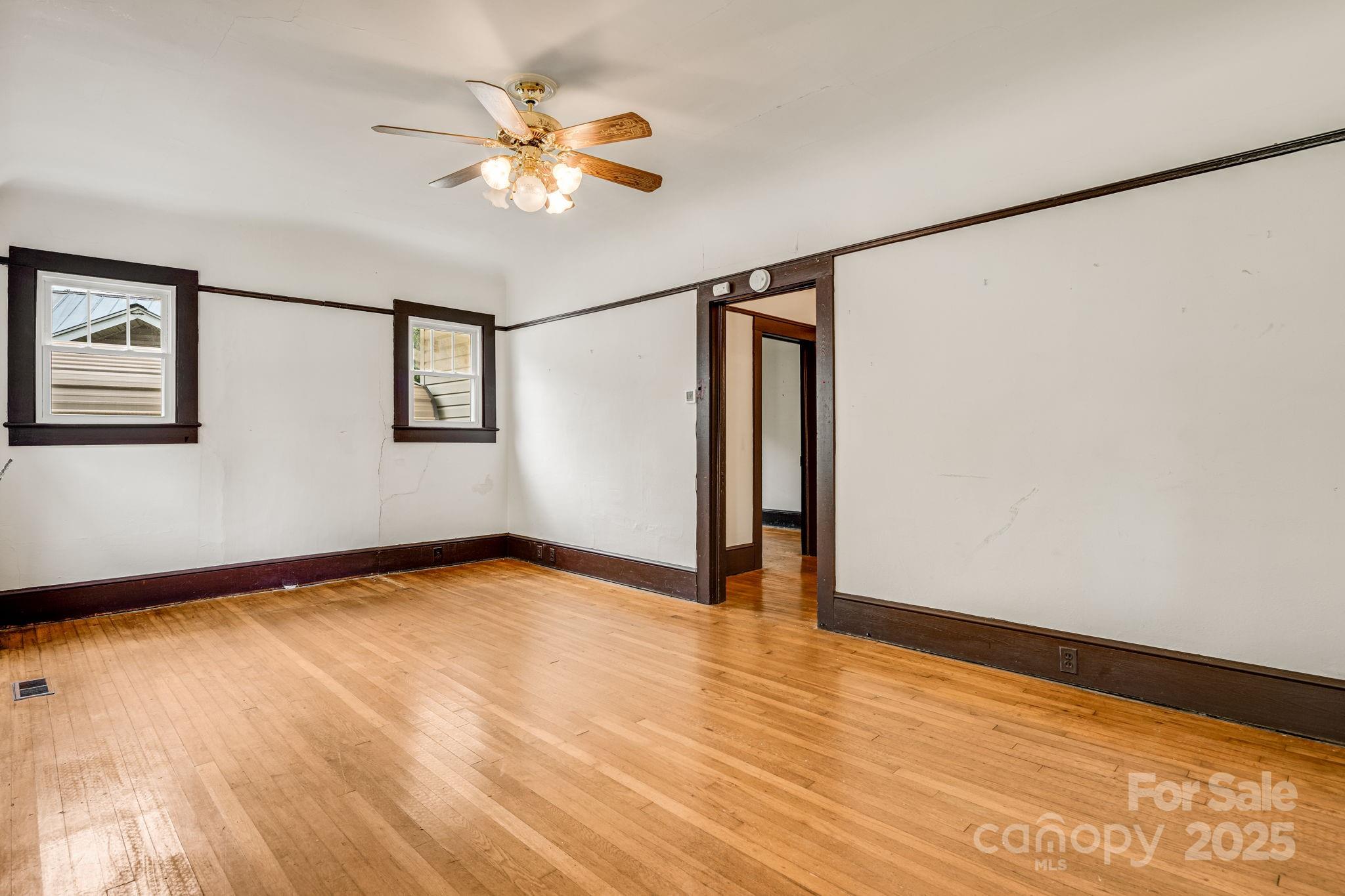 206 Rhododendron Drive Brevard, NC 28712 - Photo 8 of 36 a view of an empty room with wooden floor